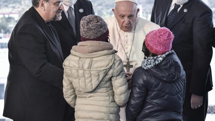 Pope Francis greets two young refugees in Greece
