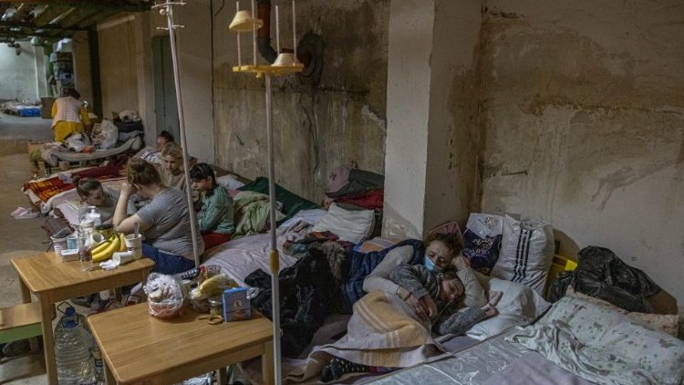 Ukrainian mothers and chidlren take shelter in the basement of a hospital in Kyiv.