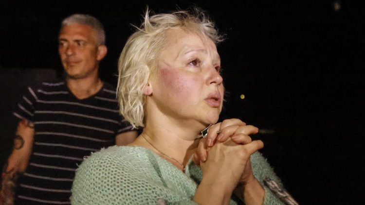 Donetsk residents react as they are evacuated from their apartments destroyed during shelling