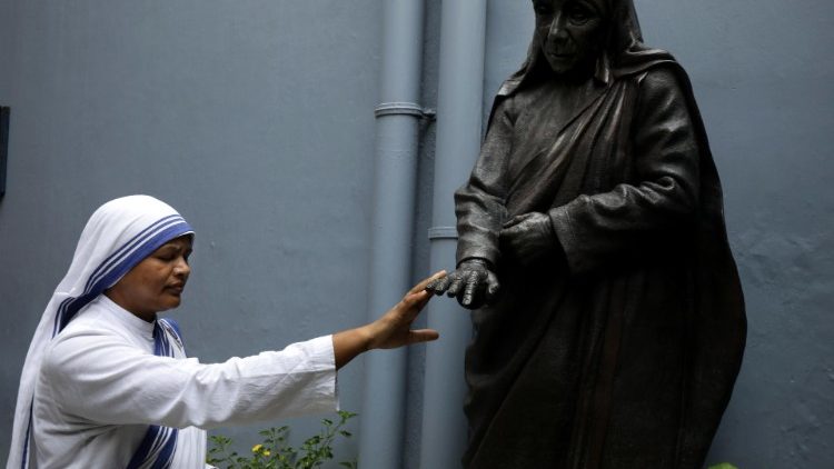 Eine Mutter Teresa-Schwester berührt die Hand einer Statue der Heiligen - Papst Franziskus sprach die indische Ordensschwester und Missionarin Mutter Teresa im Jahr 2016 heilig