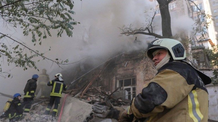 Rescuers work at the site of drone attack in downtown Kyiv
