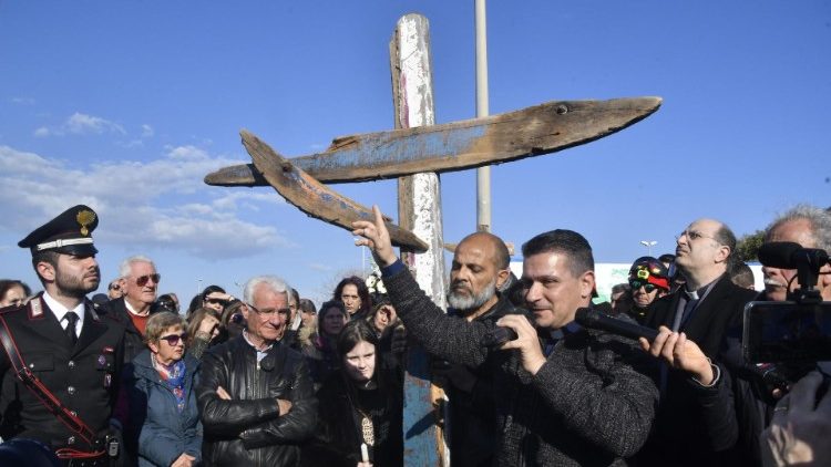 El padre Francesco Loprete presenta la cruz hecha con la madera de la barcaza que naufragó