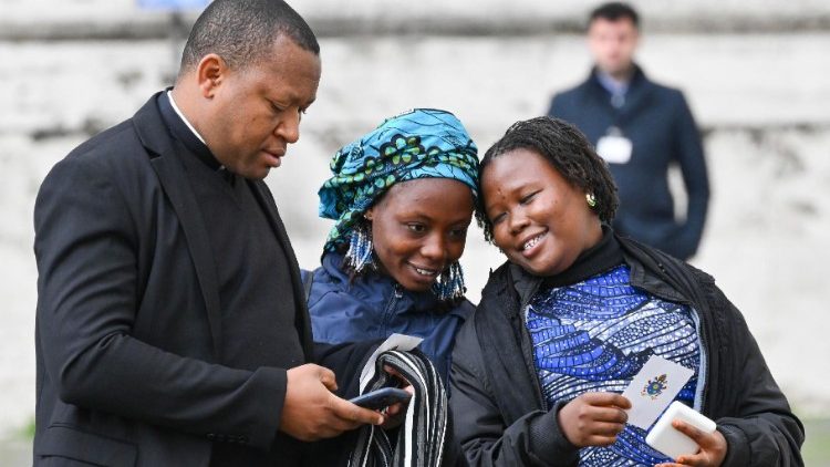 Maria (right) and Janada (left) with Fr Joseph attend the weekly General Audience on 8 March 2023