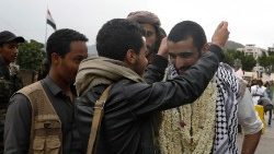 A freed Houthi prisoner is decorated with necklaces of jasmine