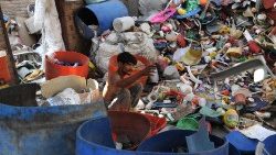 A laborer sorts plastic waste to be sold to factories that produce plastic granules in Pakistan. 