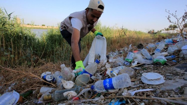 Un volontario iracheno rimuove la plastica sulle rive del fiume Tigri, nei pressi di Baghdad (Epa/Ahmed Jalil)