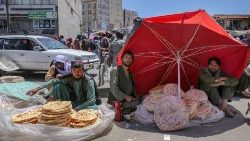 FILE: Afghan vendors sell bread on a roadside on the eve of the World Food Safety Day 2023 in Afghanistan. UN warns that 22 countries will experience an increase in acute food insecurity over the next six months.
