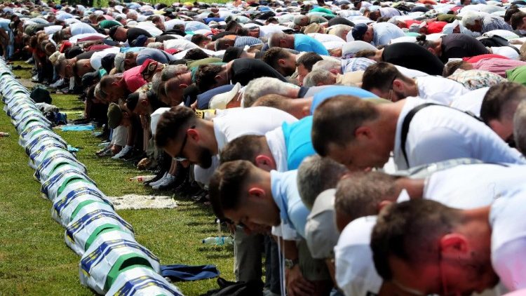 osnian Muslims pray during a funeral ceremony for thirty newly-identified Bosnian Muslim victims, at the Potocari Memorial Center and Cemetery, in Srebrenica,