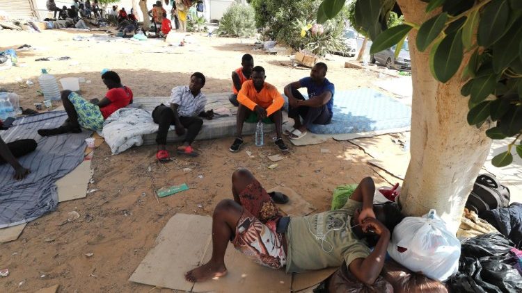 Migrants gather at a public garden in Sfax