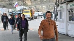 Civilians from Nagorno Karabakh cross a checkpoint on the Armenian border