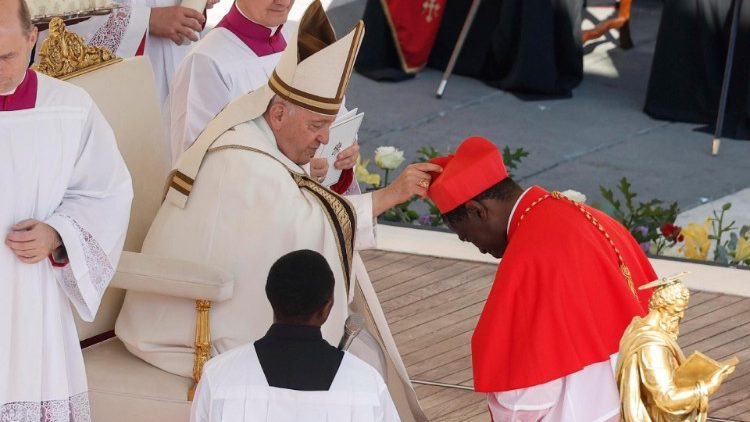 Newly elevated Cardinal - Archbishop Potrase Rugambwa receives the red hat from Pope Francis. 