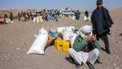 Persone colpite dal terremoto dello scorso 7 ottobre attendono soccorsi nella zona di Herat (Ansa)