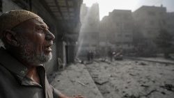 An elderly citizen views the consequences of Israeli airstrikes on Gaza City