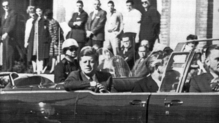 JFK pictured in a limousine just moments before he was shot in Dallas, Texas