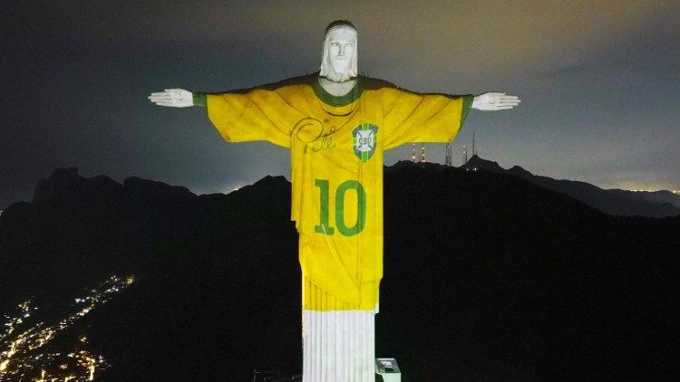 Estátua do Cristo Redentor iluminada com uma projeção da camisa da seleção brasileira de futebol usada por Pelé. (Foto: EPA/ANDRE COELHO)