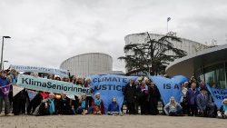 Members of Climate Seniors from Switzerland (KlimaSeniorinnen) pose with banners in front of the European Court of Human Rights in Strasbourg