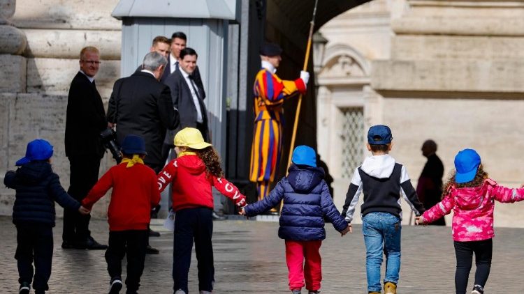 Children from Italian Catholic Action hold hands as they walk up to meet the Pope