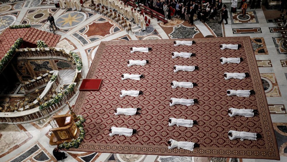 Newly ordained priests lie on the floor as Pope Francis leads a mass in Saint Peter's Basilica at the Vatican