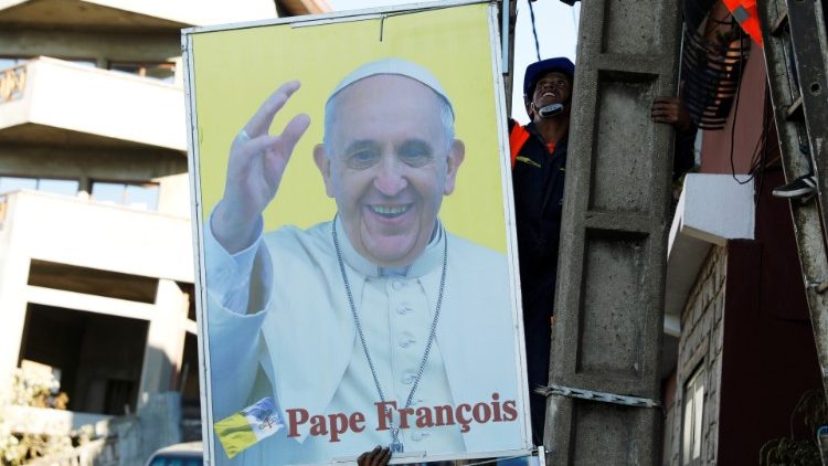 Municipal workers hang the portrait of Pope Francis ahead of his visit next week to Mozambique, Madagascar and Mauritius, in Antananarivo