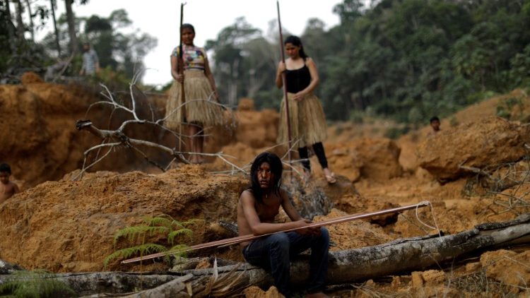 Indigenous people from the Mura tribe show a deforested area in unmarked indigenous lands, Amazon, Brazil