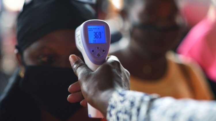 A woman getting a temperature check in Ouagadougou, Burkina Faso