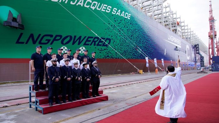 A priest blesses a new French ship built in China ahead of its maiden voyage, at the port of Shanghai.