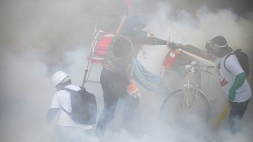 Tear gas floats around demonstrators at a protest in Yangon