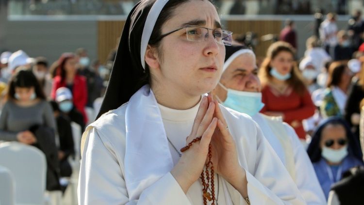 A nun holds her rosary during Pope Francis' visit to the Iraqi city of Erbil