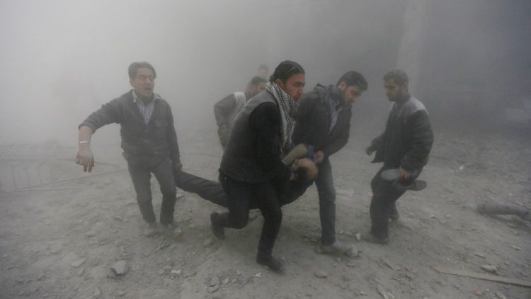File photo of Duma residents carrying an injured man after an airstrike on 2 February 2015
