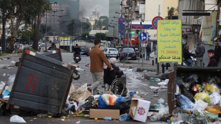 Garbage bins placed by demonstrators to block a road during a protest against the fall of the Lebanese pound in Beirut