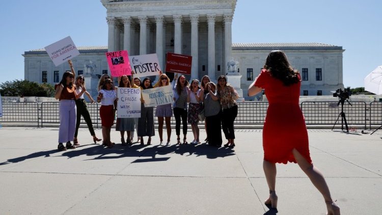 Women pose for a picture in-front of the U.S Supreme Court building in Washington