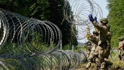Lithuanian troops set up a razor wire fence along the border with Belarus in July 2021