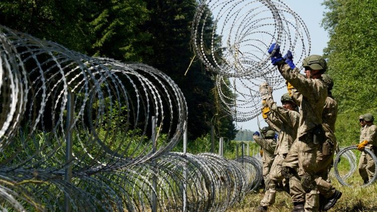 Lithuanian troops set up a razor wire fence along the border with Belarus in July 2021