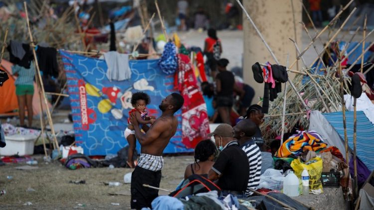 Migrants seeking asylum in the U.S. are seen at a makeshift border camp along the International Bridge in Del Rio