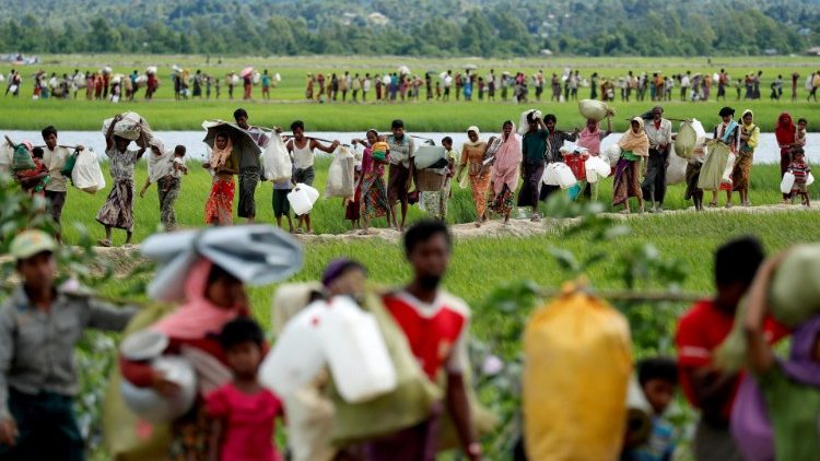 Rohingya refugees who crossed the border from Myanmar into Bangladesh walk as they try to reach refugee camps in Palang Khali