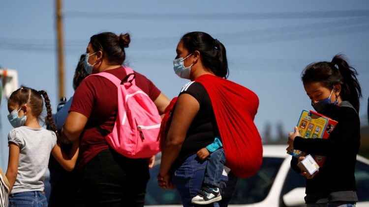 Migrants seeking asylum in the US queue to receive food in Ciudad Juarez