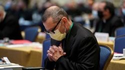 File photo of a US bishop praying during an annual meeting of the USCCB