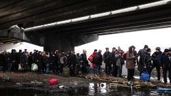 People under a bridge as they try to cross the Irpin River,  in Irpin, outside Kyiv