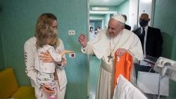 Pope Francis greets a young Ukrainian refugee