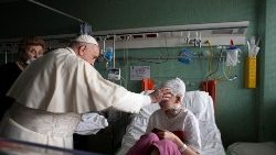 Pope Francis blesses a Ukrainian girl wounded in the war