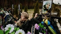 Ukraiński chłopieć przy grobie zabitego ojca