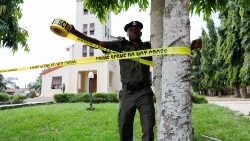 A police officer ties a crime scene tape at St. Francis Catholic Church in Owo, Nigeria.