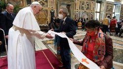 Indigenous people from Canada present the Pope with a stole during an audience on 1 April 2022