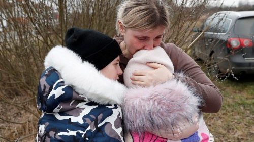 A Ukrainian woman hugs her children at a border crossing in Hungary (file photo)