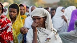 A woman stands in line to receive food donations in Tigray 