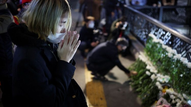 Mourners pay tribute near the scene of a stampede in Seoul