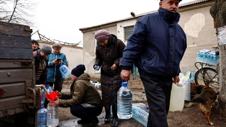 Residents fill up bottles with fresh drinking water, Ukraine