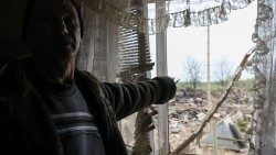 A resident of Pavlohrad points to the destruction rained on his house by Russian missiles