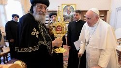 Coptic Orthodox Pope Tawadros II holds up a reliquary of the 21 martyrs