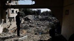 Palestinians survey their destroyed houses in Deir Al-Balah